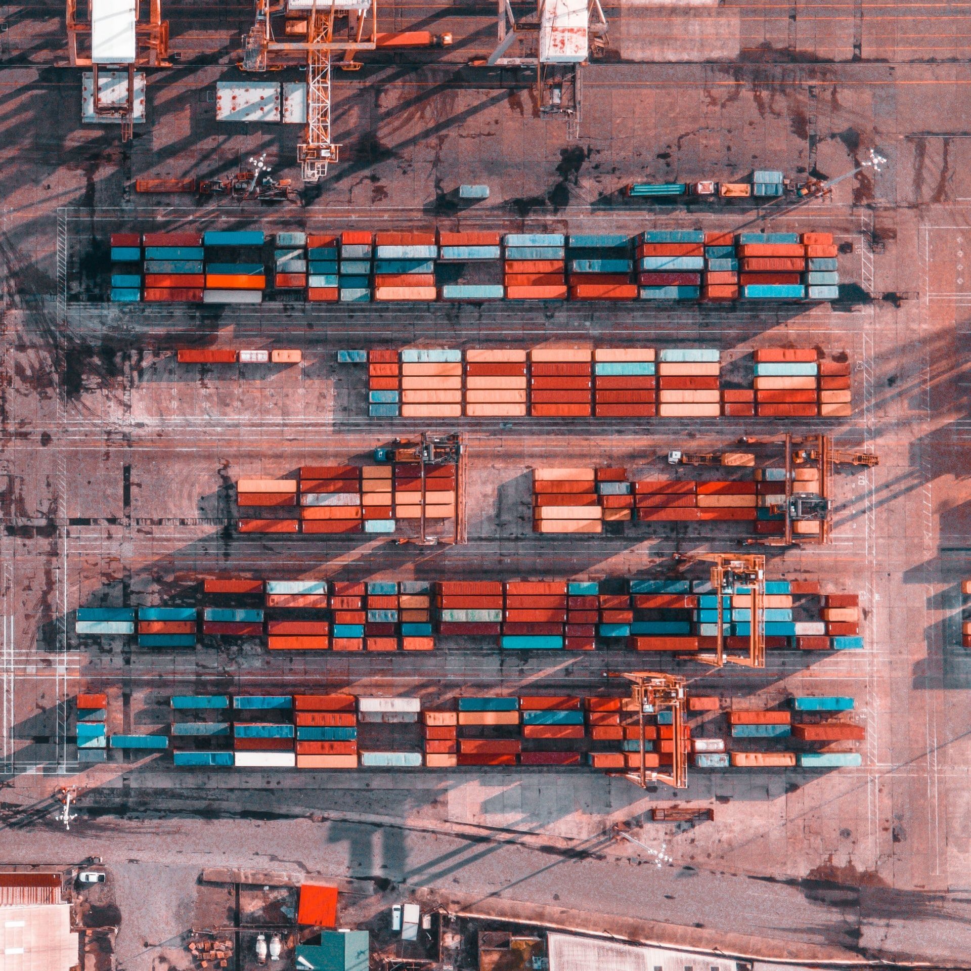 red and blue shipping containers pictured from above